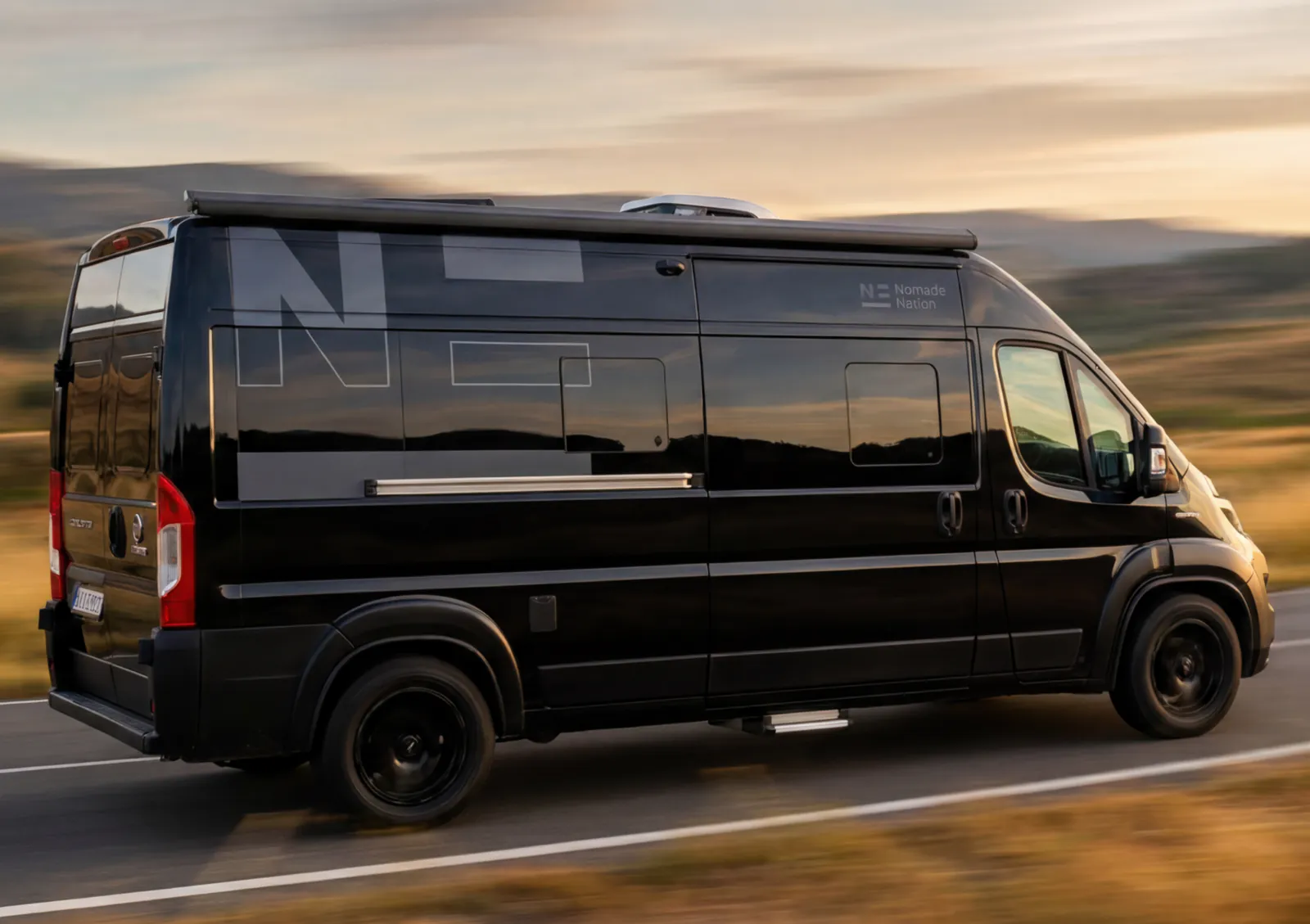 The Space with its Nomade exterior livery, driving at sunset